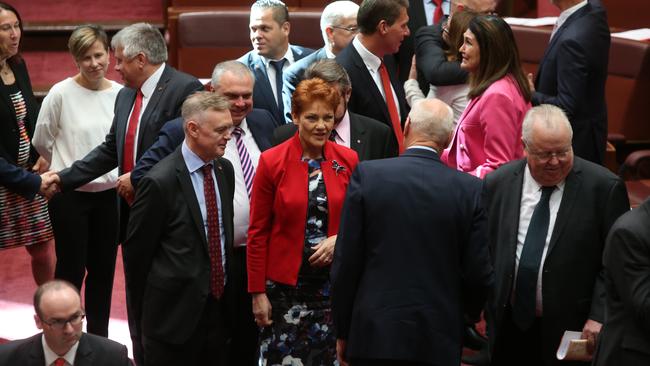 Senator Pauline Hanson congratulates Senator Jim Molan after being sworn in, in the Senate Chamber, Parliament House in Canberra.