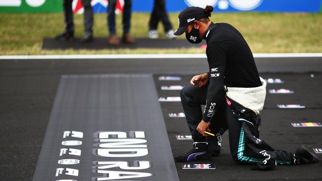 Lewis Hamilton takes a knee on the grid in support of ending racism during the F1 Grand Prix of Portugal at Autodromo Internacional do Algarve on October 25, 2020. (Photo by Peter Fox/Getty Images)