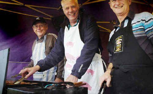 Lions Club of Lennox Head members Don Hurley (left), Dan Anderson and Bob Burnell cook sausages for local residents at a benefit barbecue and auction for the Tornado Appeal. Picture: jerad williams