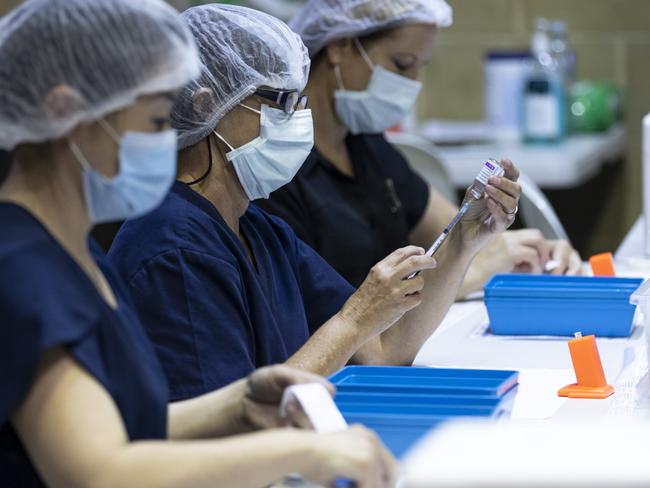 PERTH, AUSTRALIA - APRIL 28: Nurses are seen drawing up doses from a multi-dose vile of AstraZeneca Covid-19 vaccine at Claremont Showground on April 28, 2021 in Perth, Australia. The West Australian Government have opened up two new Vaccine Centres including one at Perth Airport. (Photo by Matt Jelonek/Getty Images)