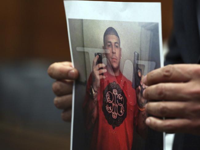 Aaron Hernandez's defence lawyer, Jose Baez, holds up a print of a photo showing Hernandez taking a selfie. Picture: AP