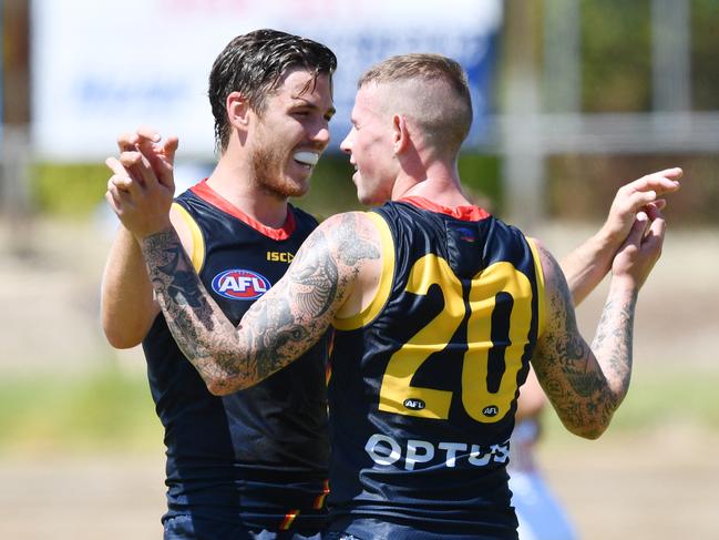 Ben Crocker and Paul Seedsman of the Crows celebrate a goal during an AFL pre-season hit out match between the Adelaide Crows and the Port Adelaide Power at Thebarton Oval in Adelaide, Saturday, February 29, 2020. (AAP Image/David Mariuz) NO ARCHIVING, EDITORIAL USE ONLY