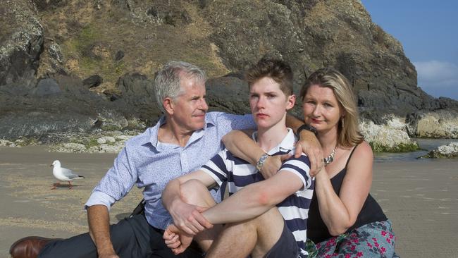 call for compassion: Connor Meldrum (middle) with father David Meldrum and Mother Kim Goodrick at Cosy Corner Tallows Beach Byron Bay. in 2019 Connor fell from the cliff face at Cape Byron shattering his skull. Now he is hoping NESA will show some compassion and allow him to complete his HSC with his close friends in 2021. Photo by Natalie Grono