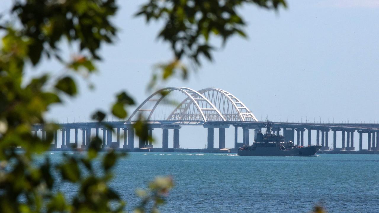 A picture taken on July 17, 2023 shows a Russian warship sailing near the Kerch bridge, linking the Russian mainland to Crimea. (Photo by STRINGER / AFP)