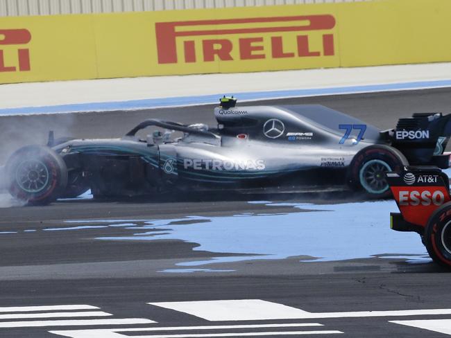 Mercedes driver Valtteri Bottas of Finland, centre, spins around after coming into contact with Ferrari driver Sebastian Vettel  (AP Photo/Claude Paris)