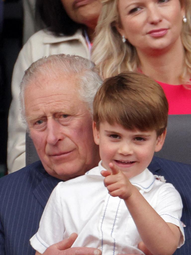 Prince Charles sits Prince Louis on his knee. Picture: AFP