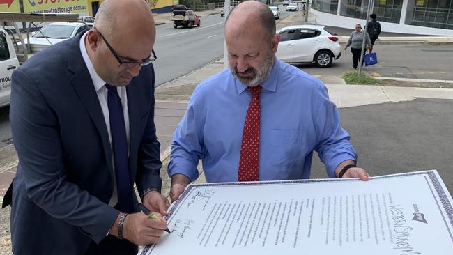 Canterbury Bankstown Mayor Khal Asfour signs the Unions NSW Even Growth campaign with secretary Mark Morey at Henry Lawson Drive.