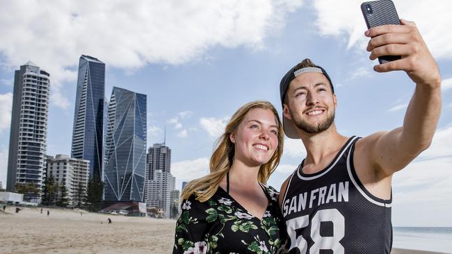 German tourists Julian Sipos, 24, and Hannah Dollriess, 22, walking along Surfers Paradise beach. Picture: Jerad Williams