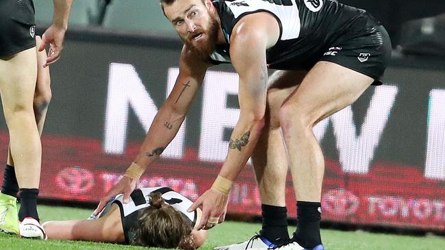 Charlie Dixon shows genuine concern for his fallen teammate. Picture: Sarah Reed