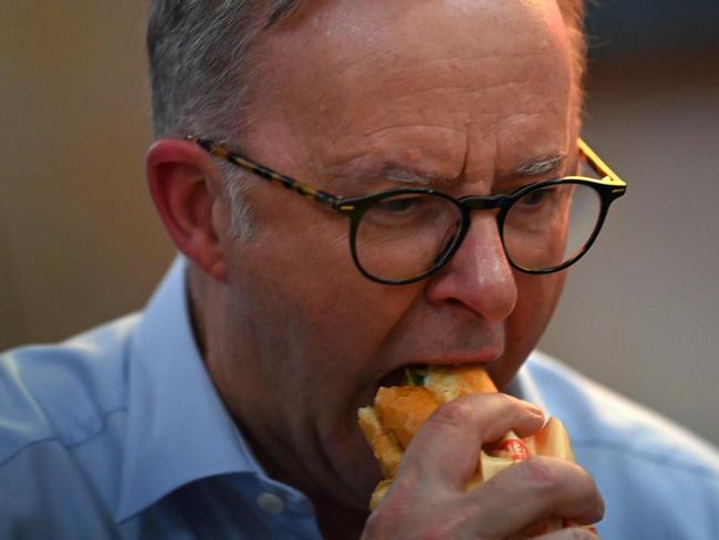 Australia's Prime Minister Anthony Albanese eats a sandwich at a street vendor's restaurant during an official visit to Vietnam in Hanoi on June 3, 2023. (Photo by NHAC NGUYEN / AFP)