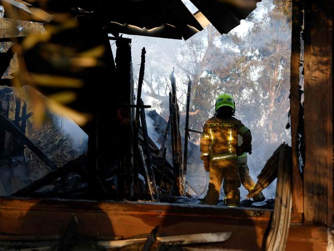 Firefighters inspect the damage at the site where rockets fired from Lebanon hit, in Kadita on the outskirts of Safed near the border with Lebanon. Picture: AFP