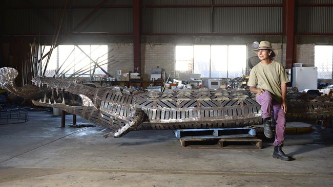 Darwin artist Techy Masero in 2013 with her famous crocodile sculpture, which now sits at the George Brown Botanic Gardens. Picture: Franchi Michael