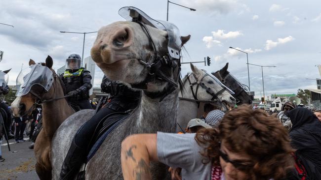 Protesters clash with mounted police outside the defence expo in Melbourne. Picture: Jake Nowakowski