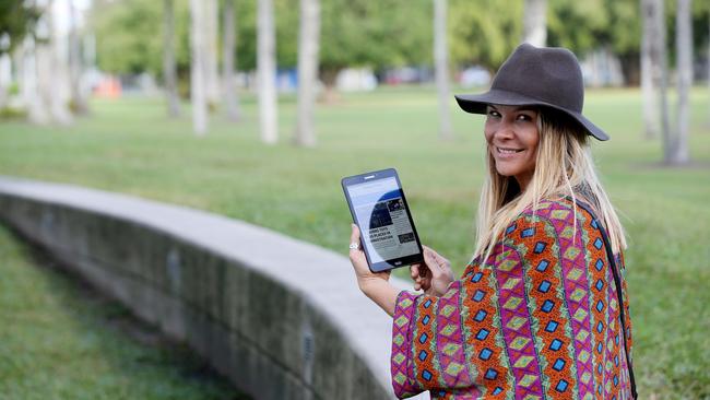 Tulani Lockhart of Whitfield reading the Cairns Post a tablet. PICTURE: STEWART MCLEAN