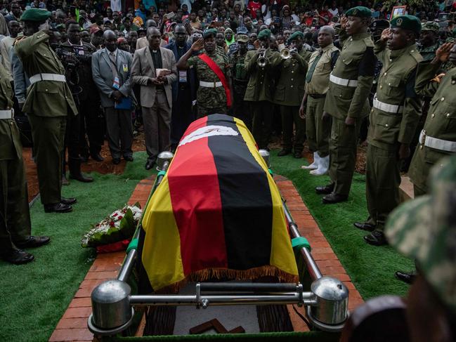 Soldiers stand near the coffin of late Olympian Rebecca Cheptegei during her burial ceremony in  Bukwo on September 14, 2024. Olympian Rebecca Cheptegei, died after her partner set her on fire in Kenya and succumbed to severe burns the week after being attacked by Kenyan Dickson Ndiema Marangach. (Photo by BADRU KATUMBA / AFP)