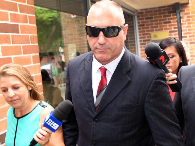 All Blacks security consultant Adrian Gard (C) leaves a Sydney court.