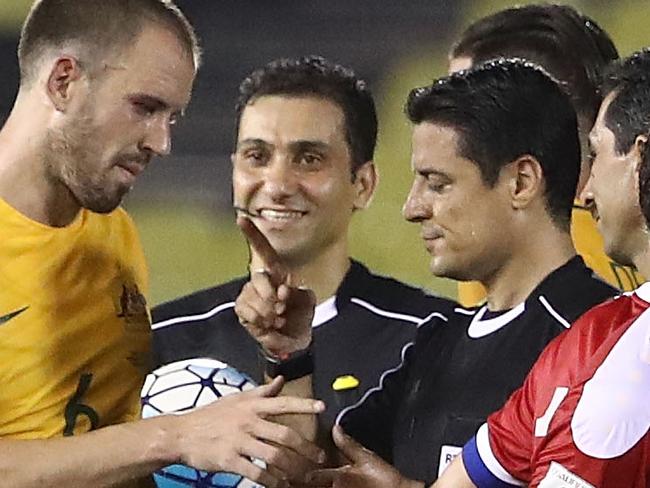 MALACCA, MALAYSIA - OCTOBER 05:  Australian players talk to referee Alireza Faghani after the 2018 FIFA World Cup Asian Playoff match between Syria and the Australia Socceroos at Hang Jebat Stadium on October 5, 2017 in Malacca, Malaysia.  (Photo by Robert Cianflone/Getty Images)