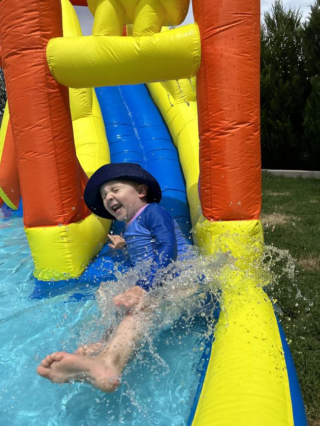 Torin Seamons enjoys some backyard summer fun on his new inflatable water park. Picture: Kathryn Seamons, Beveridge.
