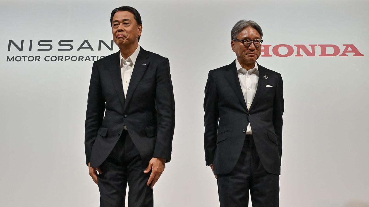 Nissan’s Makoto Uchida (left) with Honda’s Toshihiro Mibe … Uchida was sacked after merger talks with Honda collapsed. Picture: AFP