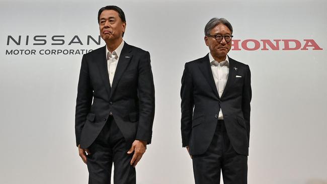 Nissan’s Makoto Uchida (left) with Honda’s Toshihiro Mibe … Uchida was sacked after merger talks with Honda collapsed. Picture: AFP