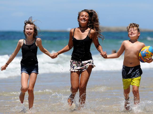 Bronte, Jasmine and Kade Langworthy love that their holiday house in Budgewoi is so close to the beach. Picture: Peter Lorimer