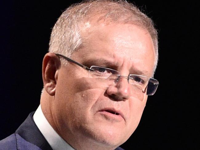 FILE - In this Feb. 23, 2020, file photo, Australian Prime Minister Scott Morrison speaks in Sydney, at a state memorial service for the victims of recent wildfires. The Australian government on Wednesday, March 11, 2020, announced a $2.4 billion (US $1.6 billion) package to help tackle the virus outbreak that has infected nearly 120,000 people worldwide, rocked financial markets and disrupted travel.(Peter Parks/Pool Photo via AP, File)