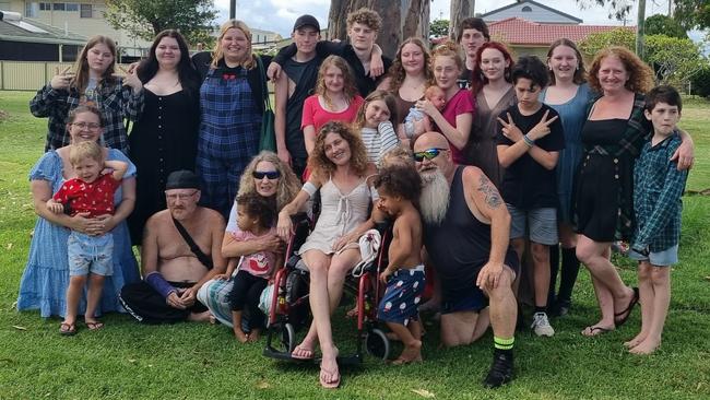 Top Left: nieces Bella, Tanisha, and Mariah Seaborn, son Riley Chisholm, nephew Jacob Tierney, daughters Lakeisha and Hailey Chisholm (Hailey holding Leokai Chisholm), nephew Jesse Tierney, nieces Mikayla and Emily Tierney, sister/carer Kelly Tierney, nephew Levi Turner, centre daughters Kianah and Selina Chisholm, nephew Lauchlan Turner (looking down with fingers up). At front, sister Sarah Minter with nephew Caleb Minter, brother Caine Tierney, Mother Christine Levett holding granddaughter Taja Tierney, Teela Tierney in front centre, son Tobias Tierney standing in front of daughter Azrael Chisholm and Dad John Tierney.