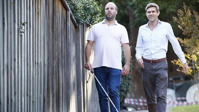 Alistair Lee (left) who is blind and his support worker Andrew Thomas at North Sydney today. Picture: Sam Ruttyn