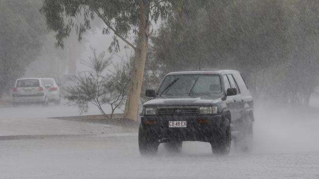 Traffic negotiates heavy rain and standing water on North Stuart Highway. File Picture: PHIL WILLIAMS