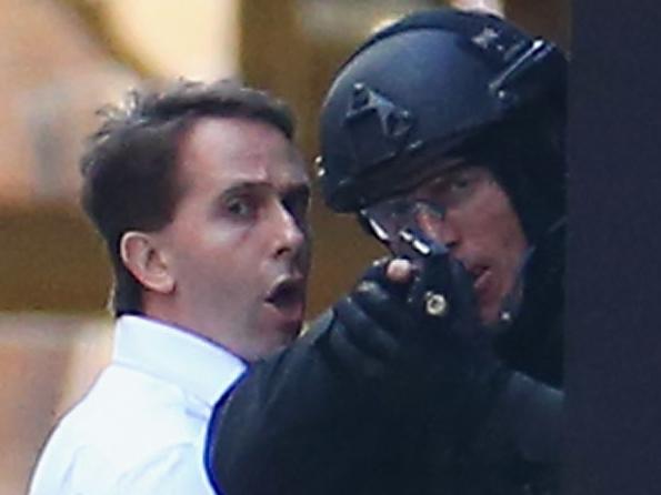 Stefan Balafoutis in white shirt - John O'Brien in blue blazer - SYDNEY, AUSTRALIA - DECEMBER 15: Two hostages run to safety outside the Lindt Cafe, Martin Place on December 15, 2014 in Sydney, Australia. Police attend a hostage situation at Lindt Cafe in Martin Place. (Photo by Don Arnold/Getty Images)