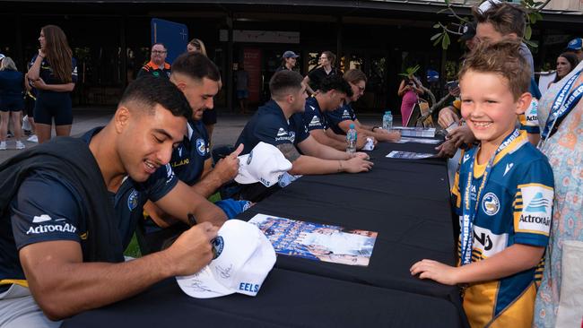 Will Penisini signing a cap for Ryan Burke at the Darwin Waterfront. Picture: Pema Tamang Pakhrin