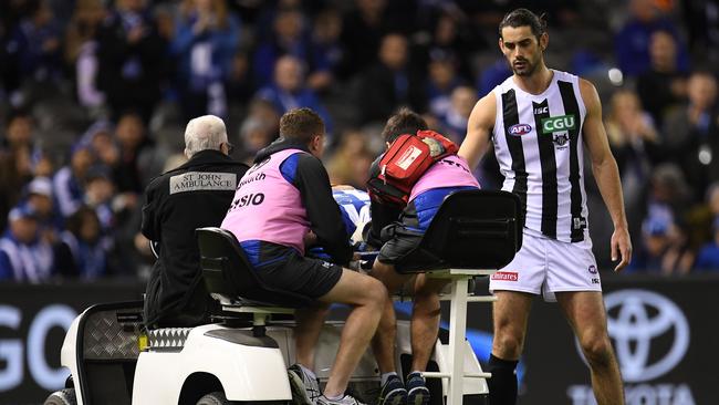 Brodie Grundy checks on Ben Brown has he is stretchered off.