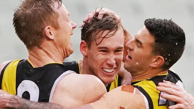 Jack Riewoldt and Jack Graham embrace Lynch after a goal in the wet against West Coast. Picture: AAP Image/Michael Dodge.