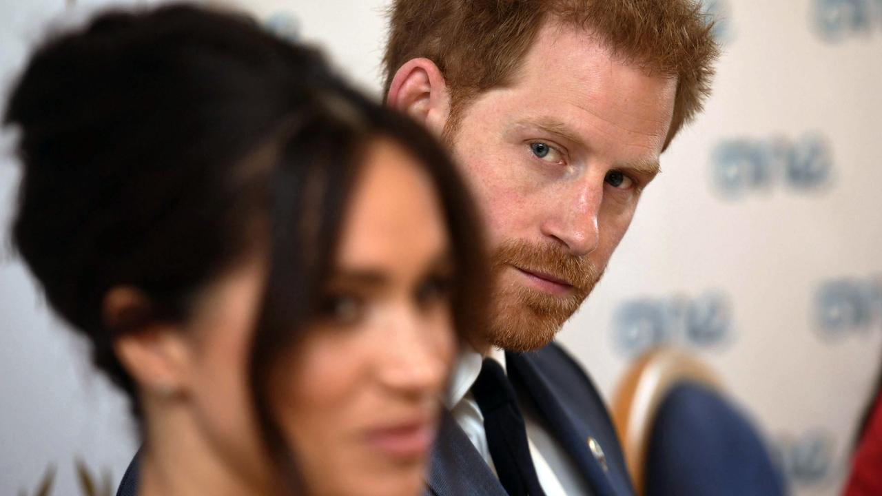 Harry watches on as his wife speaks at the event. Picture: Jeremy Selwyn/pool via AP.