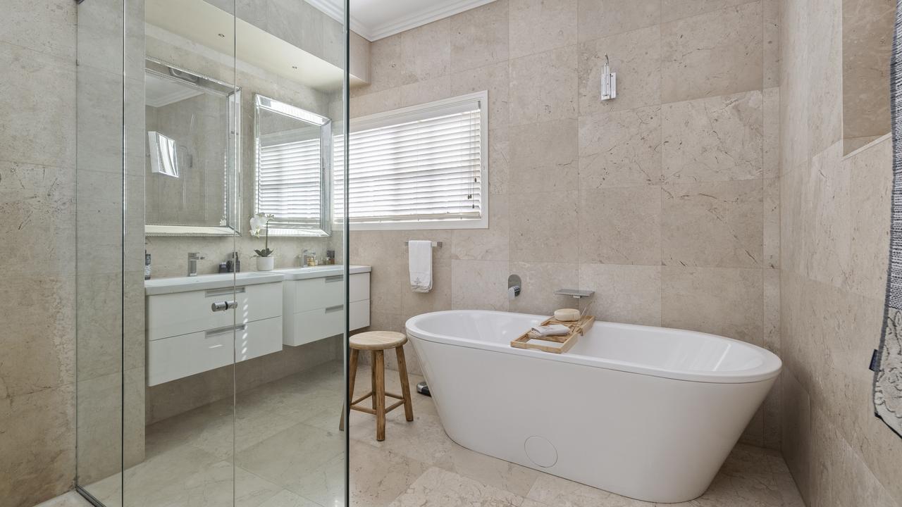 A bathtub and double vanity in one of the two bathrooms.