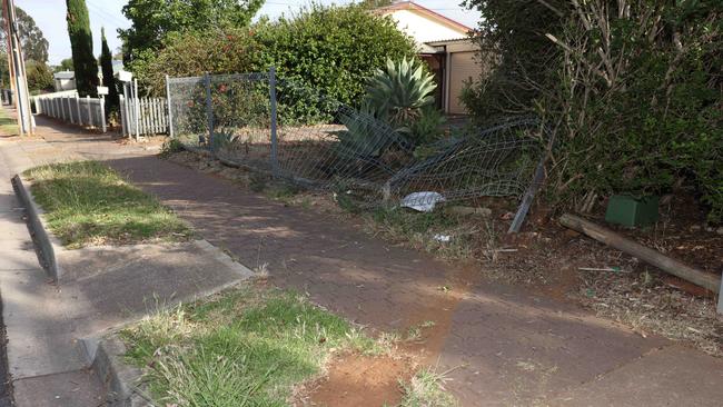 The car crashed through two fences before hitting a car and house. Picture Emma Brasier.