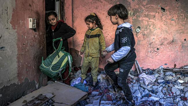 Children inspect items in the rubble in a room destroyed by Israeli bombardment in Rafah in the southern Gaza Strip on December 24, 2023. Picture: Said Khatib/AFP