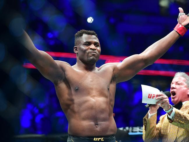 TOPSHOT - UFC 270 heavyweight world champion Cameroon's Francis Ngannou (C) reacts on introduction for fight against France's Ciryl Gane for the heavyweight title at the Honda Center in Anaheim, California on January 22, 2022. (Photo by Frederic J. BROWN / AFP)