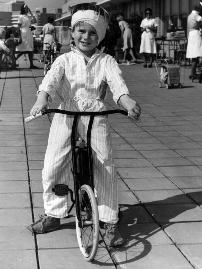 Philip, 9, rides along the balcony of the Royal Children's Hospital in 1965. Picture: The Sun News-Pictorial