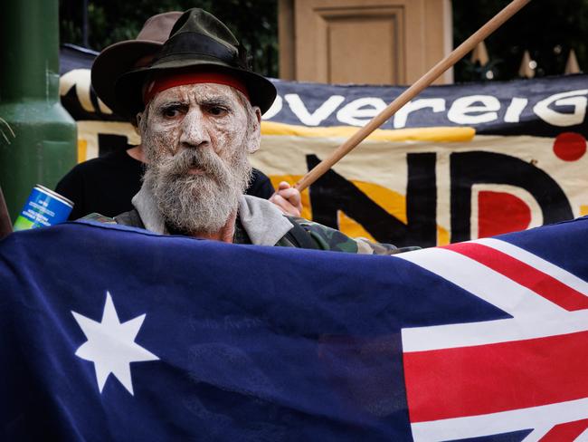 A man holds the Australian flag during an Invasion Day protest. Picture: NewsWire