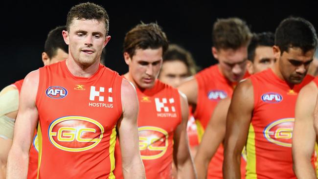 The Gold Coast Suns walk off the ground after a disappointing loss. (Photo by Quinn Rooney/Getty Images)