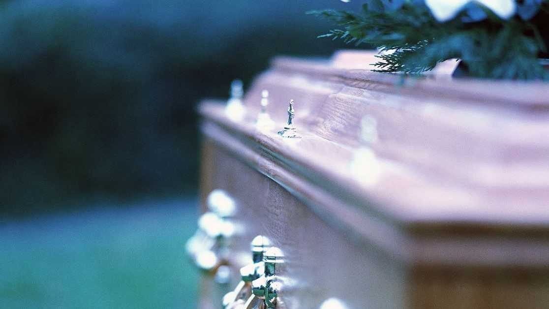 What caused burnt coffin fragments to be found at the cemetery?