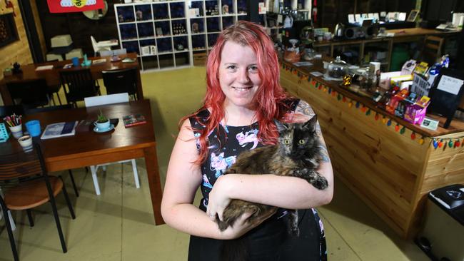 Katie Phelan with Annabelle at the Lucky Cat Cafe, Annerley, a cat cafe which has permanent resident cats and has pop up adoption days monthly. Photo: Ric Frearson