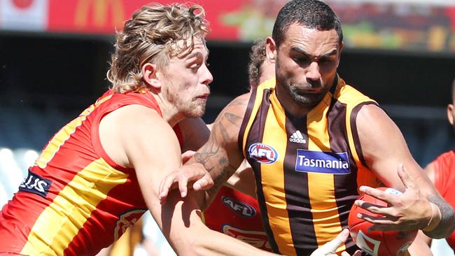 Darwin born AFL Hawk Shaun Burgoyne has his hands full in this contest with the Suns' Hugh Greenwood. Picture: Sarah Reed