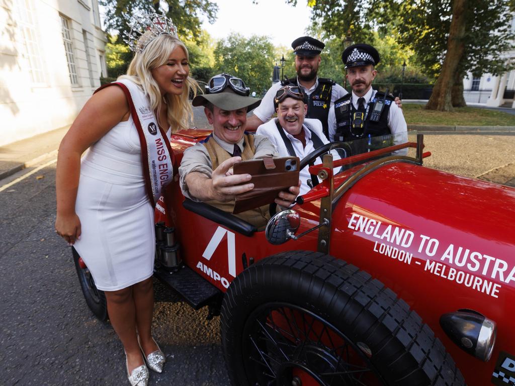 Warren Brown and Matthew Benns in their Bean roadster in London with Miss England and two policemen before they set off. Picture: Jamie Lorriman