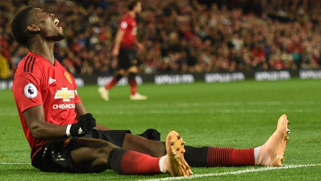 Manchester United's French midfielder Paul Pogba reacts during the English Premier League football match between Manchester United and Newcastle at Old Trafford in Manchester, north west England, on October 6, 2018. (Photo by Oli SCARFF / AFP) / RESTRICTED TO EDITORIAL USE. No use with unauthorized audio, video, data, fixture lists, club/league logos or 'live' services. Online in-match use limited to 120 images. An additional 40 images may be used in extra time. No video emulation. Social media in-match use limited to 120 images. An additional 40 images may be used in extra time. No use in betting publications, games or single club/league/player publications. /