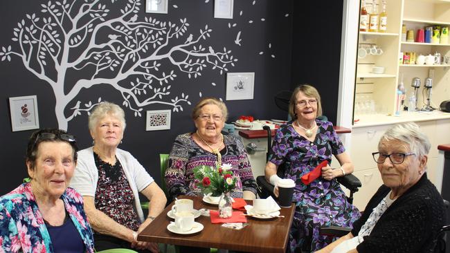 (From left) Residents May Bennett, Joan Sanster, Ruth Hoeter, Lynn Robertson, and Marjorie Large enjoying their first coffee and cake at the new cafe.