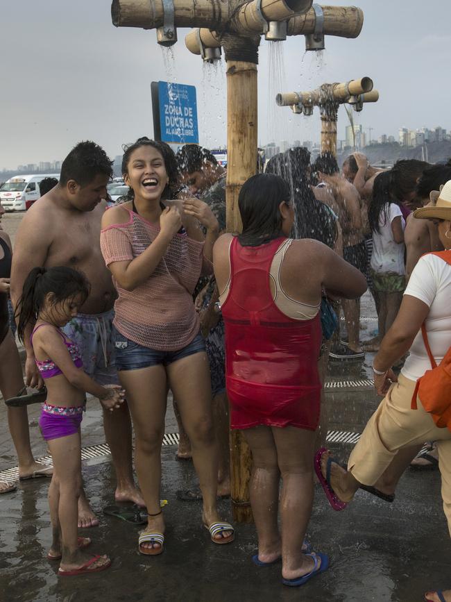 Beachgoers rinsing off at Agua Dulce beach in Lima, Peru. Picture: Rodrigo Abd