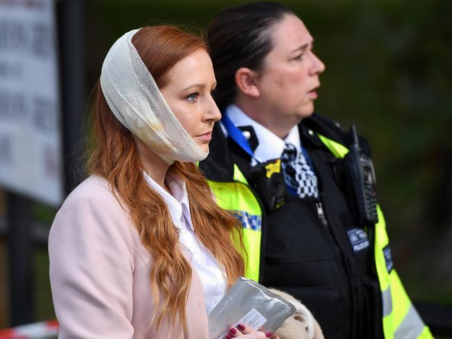 A police officer escorts an injured woman from the scene at Parsons Green Underground Station after a bomb exploded on a peak-hour train. Picture: Getty