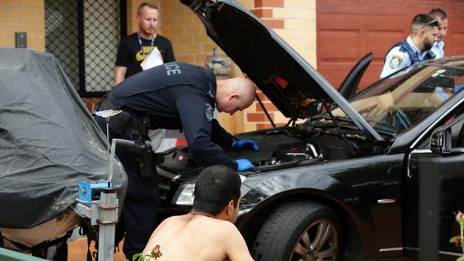 A car is searched during the raids. Picture: Jonathan Ng